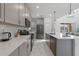 Modern kitchen with stainless steel appliances, subway tile backsplash, and quartz countertops at 9227 Sommerset Hills Dr, Davenport, FL 33896
