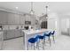 Bright kitchen with a large island with counter seating and gray cabinetry, and modern lighting at 9227 Sommerset Hills Dr, Davenport, FL 33896