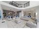 Spacious living room with high ceilings, modern decor, and an open concept design to kitchen and dining area at 9227 Sommerset Hills Dr, Davenport, FL 33896