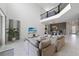 Bright and airy living room with high ceilings, tile floors, and modern decor, with a television and beach scene at 9227 Sommerset Hills Dr, Davenport, FL 33896