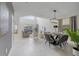 Bright and spacious living area featuring high ceilings, tile floors, and modern furniture with dining area at 9227 Sommerset Hills Dr, Davenport, FL 33896