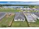 Community aerial view highlights the home, nearby lake, and surrounding construction areas with natural landscape at 928 Pearlwood Loop, Eagle Lake, FL 33839