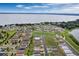 Panoramic aerial shot capturing a sprawling lakeside community featuring modern homes and scenic views under a blue sky with clouds at 928 Pearlwood Loop, Eagle Lake, FL 33839
