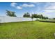 The home features a fenced yard with lush green grass perfect for outdoor enjoyment and privacy at 928 Pearlwood Loop, Eagle Lake, FL 33839