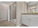 Bright bathroom featuring a tiled glass shower, granite countertop, and white vanity at 928 Pearlwood Loop, Eagle Lake, FL 33839