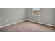 This cozy bedroom features neutral carpet, natural light from a window, and is move-in ready at 928 Pearlwood Loop, Eagle Lake, FL 33839