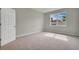 Bright bedroom featuring neutral carpeting, large windows, and a fresh coat of paint at 928 Pearlwood Loop, Eagle Lake, FL 33839
