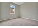 Neutral bedroom offers soft carpet, a window, and neutral color palette at 928 Pearlwood Loop, Eagle Lake, FL 33839