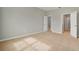 Spacious bedroom featuring neutral carpeting and ample natural light from two entry doors at 928 Pearlwood Loop, Eagle Lake, FL 33839
