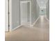 Hallway features tile flooring, neutral paint, and doorways leading to other rooms at 928 Pearlwood Loop, Eagle Lake, FL 33839