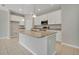 Bright kitchen with granite counters, stainless appliances, white cabinets, and tile flooring at 928 Pearlwood Loop, Eagle Lake, FL 33839