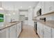 This stylish kitchen has stainless steel appliances, granite countertops, and tile flooring at 928 Pearlwood Loop, Eagle Lake, FL 33839