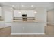 Kitchen island with granite countertops, stainless steel appliances, pendant lighting, and white cabinetry at 928 Pearlwood Loop, Eagle Lake, FL 33839