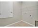 Functional laundry room with tile floor, shelving, and essential hookups for laundry appliances at 928 Pearlwood Loop, Eagle Lake, FL 33839