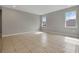 Spacious living room features tile flooring, recessed lighting, and natural light from two large windows at 928 Pearlwood Loop, Eagle Lake, FL 33839