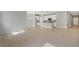 Open living space with tile flooring, recessed lighting, and seamlessly connected to the kitchen and dining area at 928 Pearlwood Loop, Eagle Lake, FL 33839