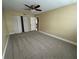 Spacious bedroom with neutral carpet, ceiling fan, and closet, bathed in natural light to create a calming atmosphere at 1000 S Semoran Blvd # 608, Winter Park, FL 32792