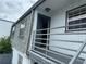 Exterior shot of a second-story entry and balcony, showcasing the architectural elements of a comfortable living space at 1000 S Semoran Blvd # 608, Winter Park, FL 32792