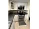 Kitchen featuring stainless steel appliances, white cabinets, and granite countertops at 1000 S Semoran Blvd # 608, Winter Park, FL 32792