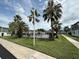 Community pool surrounded by lush greenery and palm trees at 1000 S Semoran Blvd # 608, Winter Park, FL 32792