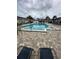 View of a community pool with lounge chairs, and a tile deck at 1000 S Semoran Blvd # 608, Winter Park, FL 32792