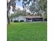 Backyard view with a pool and screened-in patio, perfect for entertaining in a private outdoor setting at 10012 Lake Louisa Rd, Clermont, FL 34711