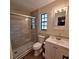 Bathroom featuring a tiled shower with glass doors and a white vanity at 10012 Lake Louisa Rd, Clermont, FL 34711