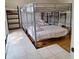 Bedroom with four metal-framed bunkbeds and tile/wood floor at 10012 Lake Louisa Rd, Clermont, FL 34711