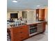 Kitchen island with a cooktop and stainless steel oven and dishwasher at 10012 Lake Louisa Rd, Clermont, FL 34711