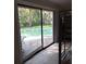 View from bedroom through sliding glass doors to the inviting pool and outdoor area at 10012 Lake Louisa Rd, Clermont, FL 34711