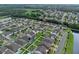 Aerial view of the community showcasing the neighborhood layout, homes, and a picturesque pond at 10078 Hampshire Oaks Dr, Orlando, FL 32825