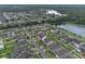 Aerial view of the community showcasing the neighborhood layout, homes, and a picturesque pond at 10078 Hampshire Oaks Dr, Orlando, FL 32825