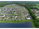 Beautiful aerial view of a residential neighborhood with lush landscaping and community lake at 10078 Hampshire Oaks Dr, Orlando, FL 32825