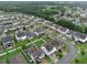 Aerial shot of houses in a community featuring solar panels and landscaping at 10078 Hampshire Oaks Dr, Orlando, FL 32825