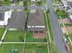 Aerial perspective highlighting backyard with screened porch, garden, and neatly maintained landscaping at 10078 Hampshire Oaks Dr, Orlando, FL 32825