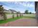 Beautiful backyard showcases a brick patio, lush lawn, and a privacy fence for a tranquil setting at 10078 Hampshire Oaks Dr, Orlando, FL 32825