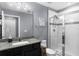 Elegant bathroom with granite countertops, dark wood cabinets, and glass shower at 10078 Hampshire Oaks Dr, Orlando, FL 32825