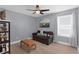 Spare bedroom with a ceiling fan, light wood floors, comfortable sofa, and decorative accents at 10078 Hampshire Oaks Dr, Orlando, FL 32825
