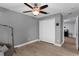 Gray bedroom with wood floors, ceiling fan, neutral paint, and a closet at 10078 Hampshire Oaks Dr, Orlando, FL 32825