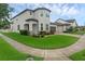 Charming two-story home featuring a landscaped front yard and bay window at 10078 Hampshire Oaks Dr, Orlando, FL 32825