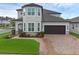 Stunning two-story home with a well-maintained lawn and charming facade at 10078 Hampshire Oaks Dr, Orlando, FL 32825