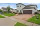 Beautiful home featuring a two-car garage and brick paver driveway at 10078 Hampshire Oaks Dr, Orlando, FL 32825