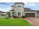 Attractive gray home with neat landscaping and a two-car garage at 10078 Hampshire Oaks Dr, Orlando, FL 32825