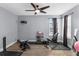 Bright home gym features a ceiling fan, exercise equipment, and resilient flooring at 10078 Hampshire Oaks Dr, Orlando, FL 32825