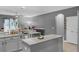 Well-lit kitchen featuring granite counters, stainless steel appliances, and gray cabinets at 10078 Hampshire Oaks Dr, Orlando, FL 32825