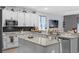 Well-lit kitchen featuring granite counters, stainless steel appliances, and white cabinets at 10078 Hampshire Oaks Dr, Orlando, FL 32825
