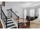 Inviting living room with hardwood floors, a cozy couch, and stairs at 10078 Hampshire Oaks Dr, Orlando, FL 32825