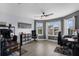 Bright home office featuring a ceiling fan, multiple desks, and large windows with natural light at 10078 Hampshire Oaks Dr, Orlando, FL 32825