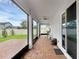 Enclosed brick patio with ceiling fan, outdoor seating, and views of the backyard at 10078 Hampshire Oaks Dr, Orlando, FL 32825