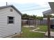 Backyard featuring a covered patio area, fencing, and mature trees for added privacy at 102 Luna Rd, Auburndale, FL 33823
